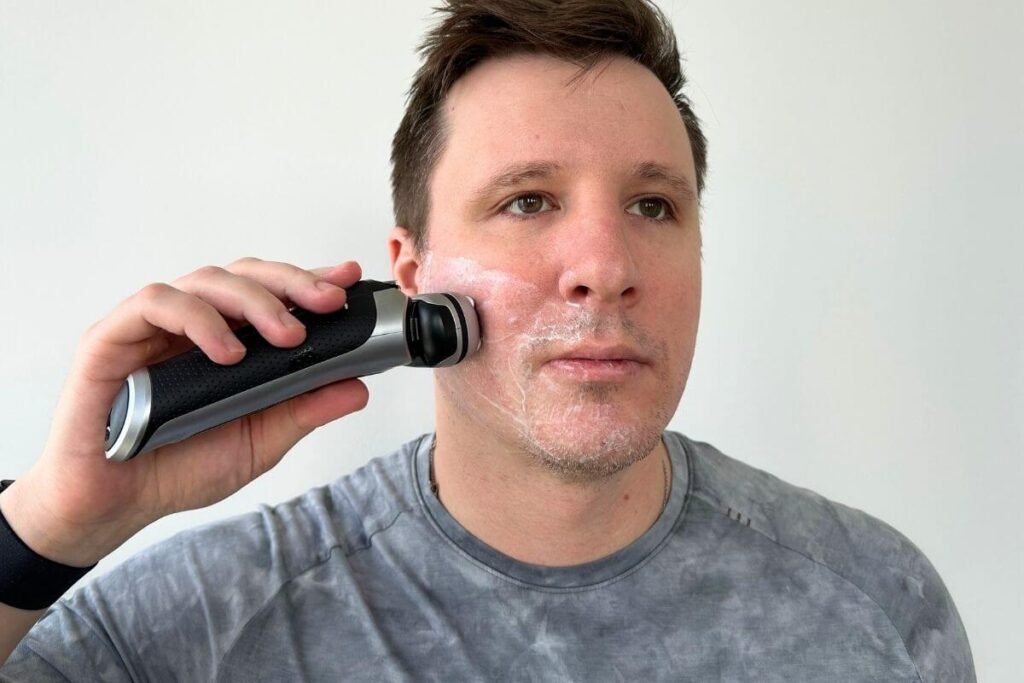 Man using foil electric shaver with shaving cream for wet shave
